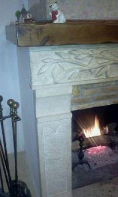 Fireplace of Lemons:cladding in listel Etrusca stone and beam in travertine.